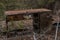 Abandoned old nearly collapsed radiative wooden table in Chernobyl ghost town