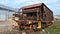 Abandoned old rusty freight industrial wagon on factory railroad at sunny day. No people