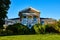 Abandoned old townhouse home with white pillars and overgrowth in America