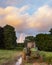 Abandoned Old tractor in farmerâ€™s field during beautiful Summer sunset in English countryside landscape