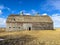 While abandoned, this old wooden livestock barn structure still stands tall and proud over the plains of South Dakota