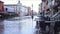 Abandoned outdoor cafe furniture stands on flooded street