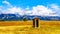 An abandoned Outhouse at Mormon Row with in the background cloud covered Peaks of the Grand Tetons In Grand Tetons National Park