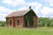 Abandoned overgrown brick old school house building