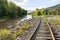 Abandoned, overgrown railroad train tracks along a rural river repurposed as trails for rail bikes in the Catskill Mountains of Ne