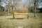 Abandoned park bench in autumn or winter season. Waiting moment, tranquility scene and simplicity concept