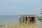 Abandoned pier with grass in foreground