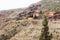 Abandoned post-industrial buildings in dry grass landscape in CHina