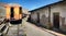 The abandoned railway wagons with damaged warehouse buildings