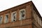 Abandoned red brick building with three windows