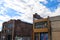 Abandoned red brick buildings with colorful graffiti with a gorgeous blue sky with powerful clouds in downtown Memphis