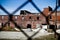 Abandoned Red Brick Factory Behind Chain-link Fence in Pierceton, Indiana