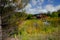 An abandoned red sinking barn sinks into a lake near Zimmerman, MN