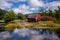 An abandoned red sinking barn sinks into a lake near Zimmerman, MN in rural minnesota