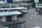 Abandoned restaurant with red and white barrier tape which as a new normal is securing every second table.