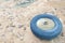 Abandoned Rubber Wheel on White Sand at the Sea Background