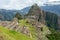 Abandoned ruins of Machu Picchu Incan citadel, the maze of terraces and walls rising out of the thick undergrowth, Peru