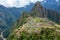 Abandoned ruins of Machu Picchu Incan citadel, the maze of terraces and walls rising out of the thick undergrowth, Peru