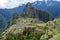 Abandoned ruins of Machu Picchu Incan citadel, the maze of terraces and walls rising out of the thick undergrowth, Peru