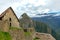 Abandoned ruins of Machu Picchu Incan citadel, the maze of terraces and walls rising out of the thick undergrowth, Peru