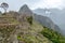 Abandoned ruins of Machu Picchu Incan citadel, the maze of terraces and walls rising out of the thick undergrowth, Peru