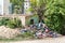 Abandoned rural damaged house in the ghetto near new residential building in the city used as garbage dump with junk and litter in