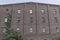 Abandoned rust belt auto warehouse and factory with worn brick facade - Worn, Broken and Forgotten