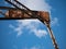 Abandoned, rusted, industrial lifting crane / winch in a disused dock