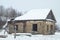 Abandoned rustic cold old house with a collapsed roof. Winter nature of secluded countryside. Russia life remote place