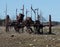 Abandoned, rusting vintage farm equipment in an open field