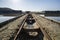 Abandoned rusty mine railway next to river