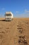 Abandoned rusty old truck on the empty desert highway road under the scorching sun