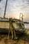 Abandoned sailing boat or yacht laying on beach in Kribi, Cameroon during sunset, Africa