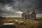 abandoned schoolhouse, with desks and blackboards still in place, against stormy sky