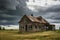 abandoned schoolhouse, with desks and blackboards still in place, against stormy sky