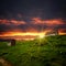 Abandoned shacks on the hill and sunset clouds