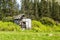 Abandoned shed in the Scottish Highlands with a broken rusted bike outside