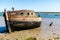 An abandoned ship wreak that is beached up on Orford beach in Suffolk