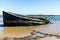 An abandoned ship wreak that is beached up on Orford beach in Suffolk