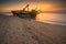 An abandoned shipwreck on a sandy beach