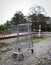 Abandoned Shopping Cart Beside Train Tracks.