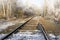 Abandoned single track railway line in sunny freezing weather
