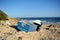 Abandoned small wooden boat -patera- on a beach near Tarifa, coast of Andalusia, Spain.