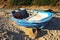 Abandoned small wooden boat -patera- on a beach near Tarifa, coast of Andalusia, Spain.