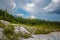 Abandoned talc quarry overgrown with trees