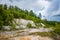 Abandoned talc quarry overgrown with trees