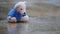 Abandoned toy bear in a puddle in the rain.