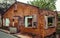 Abandoned tumbledown house, windows and door removed uninhabitable condition, build with  refractory clay firebricks, isolated in