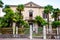 Abandoned two floors classical Italian house with growing palm in the garden metal fence and gate at the entrance in Riva del