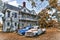 Abandoned Two Story Farmhouse with Three Vintage Automobiles